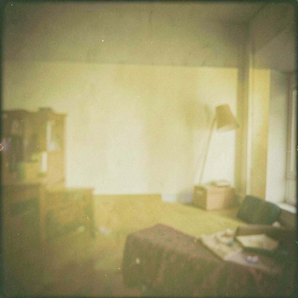 A grainy film photograph of a sunlit homeschool workspace with books and supplies on a wooden desk, warm and inviting atmosphere.